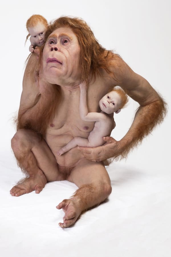 Sculpture of ape-like creature with 2 human babies