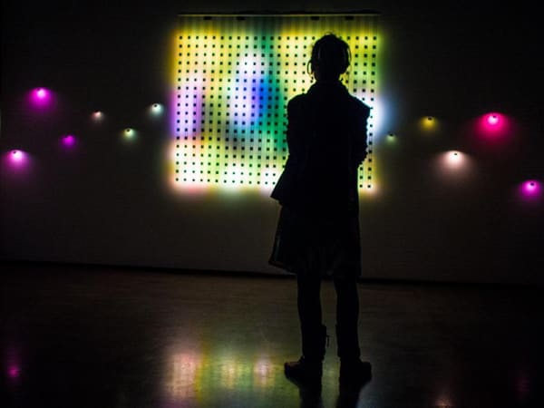A gallery visitor watches an old home movie reproduced through low resolution LED imaging at San Jose Museum of Contemporary Art on Feb. 5.