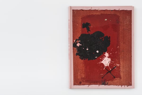 Front cover of book with red cover and black and white splatter