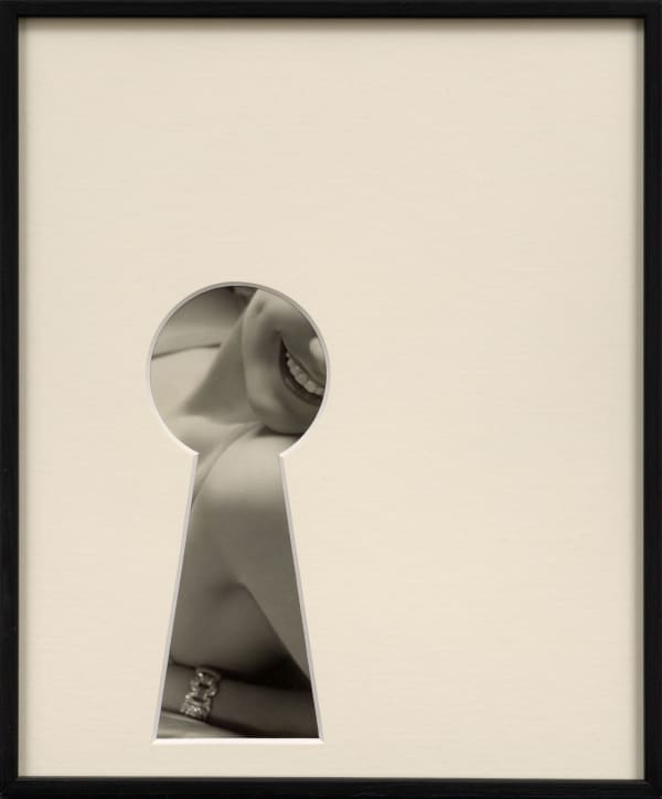 framed black and white photograph with an overmat cut in the shape of a keyhole revealing smiling woman by Sissi Farassat