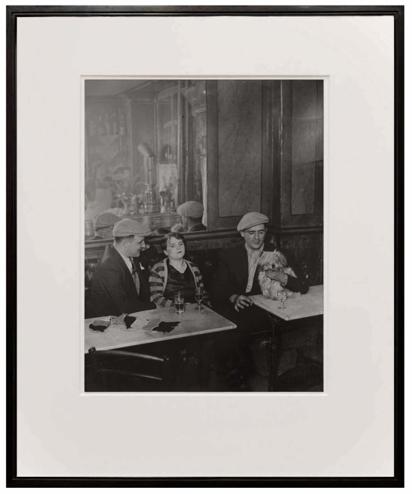 woman and two men at cafe from Paris de Nuit by Brassai