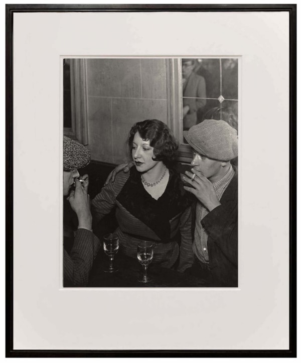 framed photograph of couple at the table smoking cigarette from Paris de Nuit by Brassai