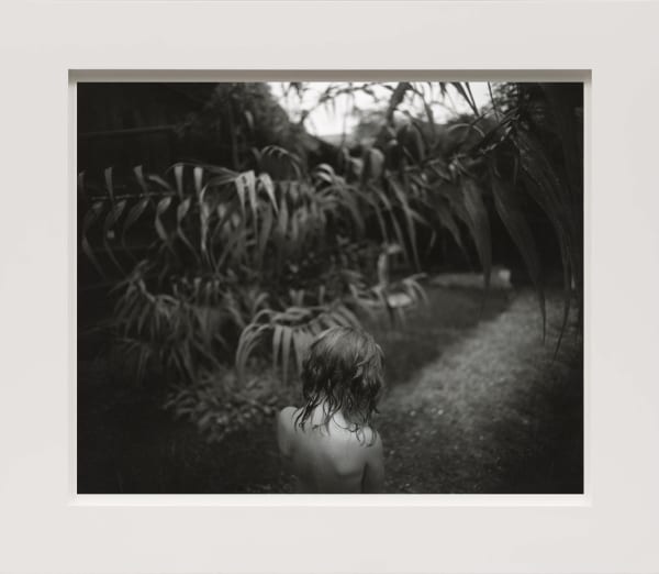 Virginia with wet hair and Arundo donax plants in background, from the Immediate Family series by Sally Mann