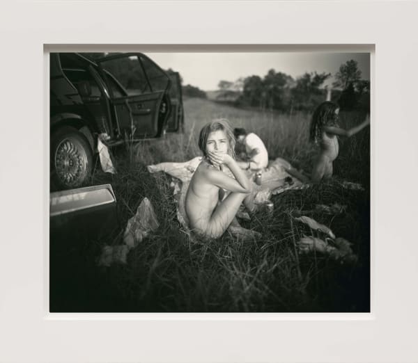 Three children having picnic in the grass after Monet's Luncheon on the Grass by Sally Mann
