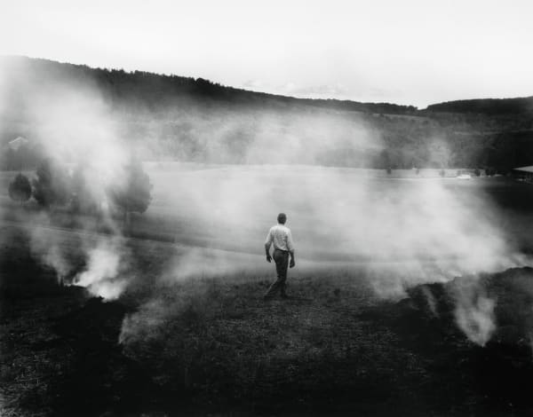 Sally Mann The Turn in A Thousand Crossings at the National Gallery of Art, Larry Mann the photographer's husband in foreground with farmland and mist
