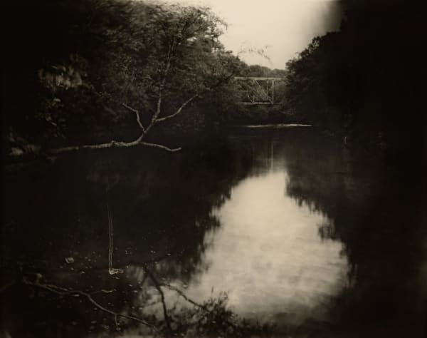 Sally Mann "Deep South, Untitled (Bridge on Tallahatchie)” 1998 photograph of river in Mississippi with bridge and trees in background from A Thousand Crossings