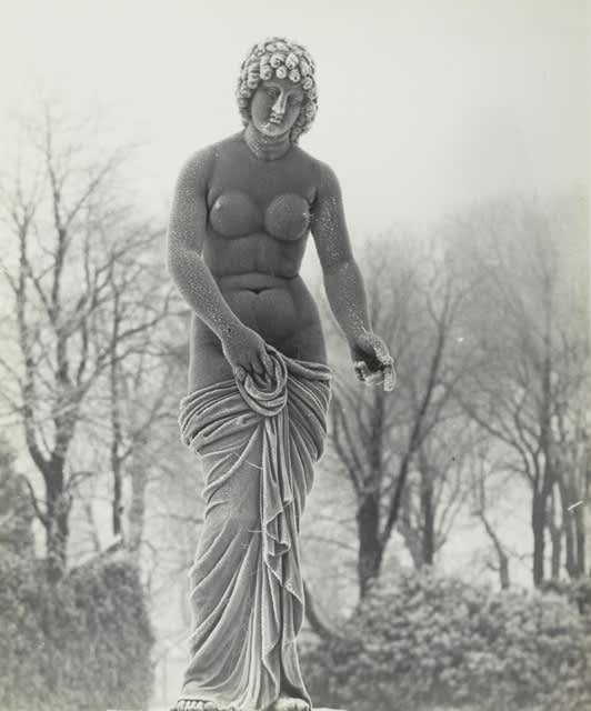 Bill Brandt photograph of statue of nude woman with winter landscape
