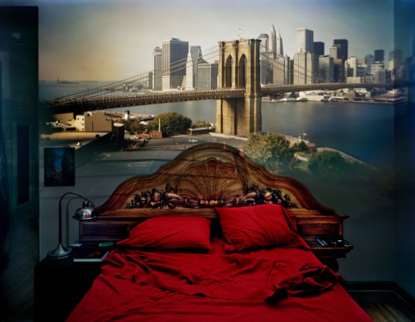 Abelardo Morell camera obscura photograph of red bed overlooking Brooklyn Bridge in New York City