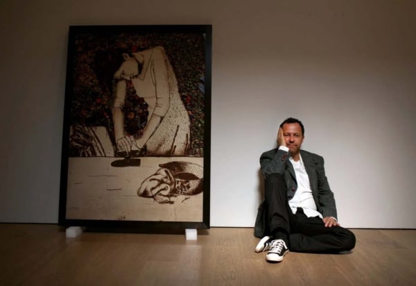Vik Muniz with one of the portraits in his “Pictures of Garbage” series