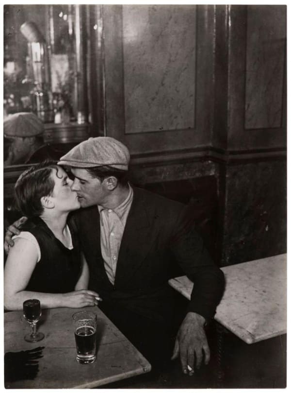 Brassai photograph of lovers kissing in Parisian cafe, 1931