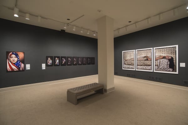 Installation shot of Boushra Almutawakel and Lalla Essaydi's work from the Bullets Revisited series in the She Who Tells a Story exhibition at the MFA Boston