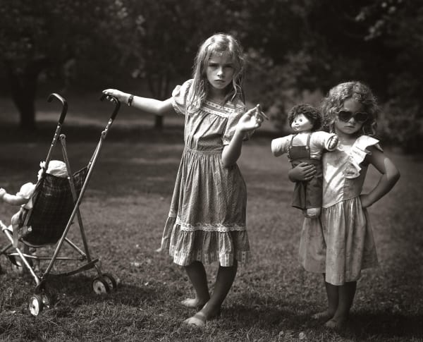 Virginia and Jessie play pretending to be young mothers, by Sally Mann
