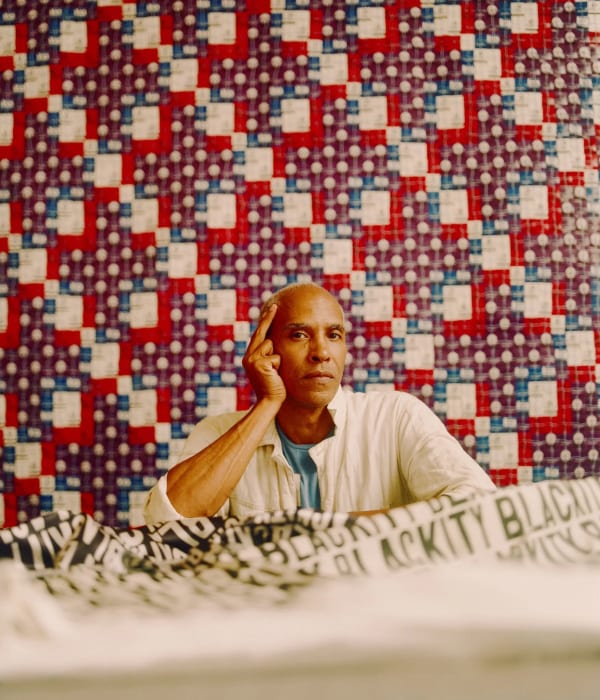 portrait of Ron Norsworthy in front of DARNstudio's matchbook quilt