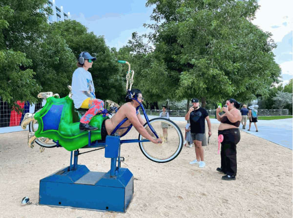Artist Guadalupe Rosales rides Rafa Esparza as part of his "Corpo RanfLA: Terra Cruiser" (2022), at Art Basel Miami Beach.