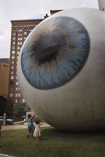 Children examine a 30-foot-tall sculpture by Chicago artist Tony Tasset in Chicago’s Pritzker Park in 2010. The piece was on temporary display.GETTY IMAGES