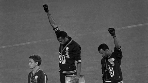 Extending gloved hands skyward in protest, American athletes Tommie Smith, center, and John Carlos are pictured after receiving medals for the 200-meter run at the Summer Olympic Games in Mexico City on Oct. 16, 1968. Australian silver medalist Peter Norman is at left. AP