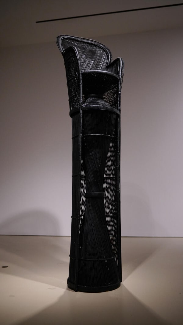 Esmaa Mohamoud, A Seat Above the Table (Warren Moon), 2019, found rattan peacock chair, rattan, paint, tape, plastic, adhesive, nails, 290 × 66 × 66 cm. Courtesy of the artist.