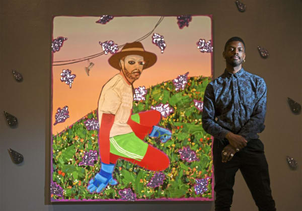 Devan Shimoyama in front of one of his paintings in Cry, Baby, at the Warhol Museum. Photo: Steve Mellon/Post-Gazette