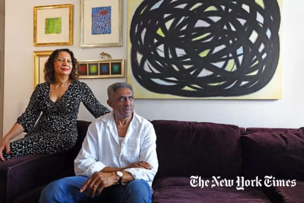 Fatima Shaik and James Little in their Garment District apartment with, clockwise from top left, two untitled 1972 works by Alma Thomas; Untitled (1978) by Toshio Iwasa; Untitled (2001) also by Iwasa; and, perched over that frame, Money Lures, made of shredded money, by Richard Mock (1975).Credit: Andrea Mohin/The New York Times