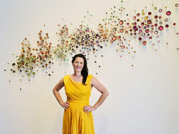 Julie Maren in front of one of her vibrant installations. Photo credit: Jennifer Maren