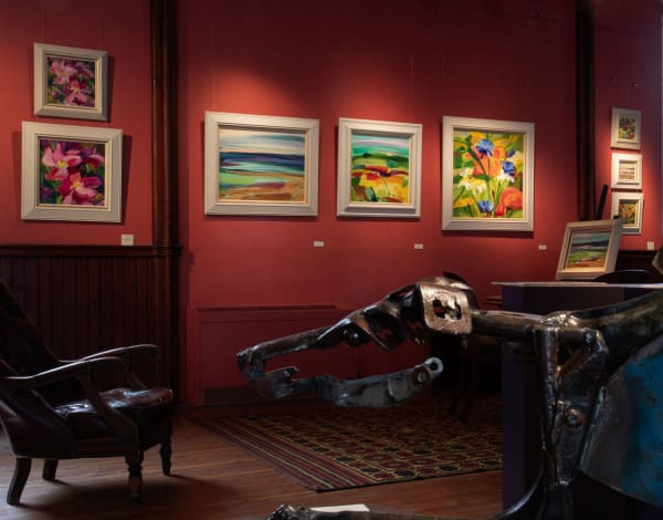 Paintings by Shona Barr hanging in Kilmorack Gallery with a Helen Denerley lurcher sculpture