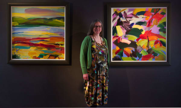 Shona Barr with two paintings in March 2022