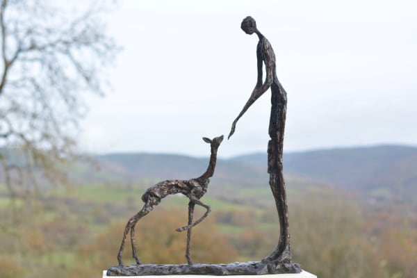 Bronze sculpture of woman and fawn