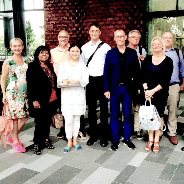 Mamakan shows a group of Danish visitors around Singapore