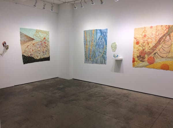 Installation shot of various art pieces by Nancy Cohen. From left to right, the pieces are "Issue", "Breakwater", "Scrim", "Diffusion", "Fissure" and "Public Market".