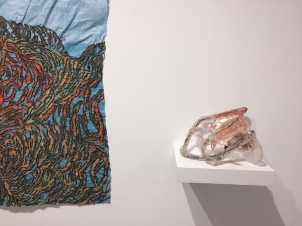 Installation shot of two different art pieces by Nancy Cohen. The pieces are "Low Tide" (left) and "Intercoastal" (right). Only the bottom right corner of "Low Tide" was shot.