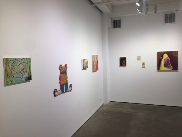 Gallery photograph of an installation featuring eight different art pieces.