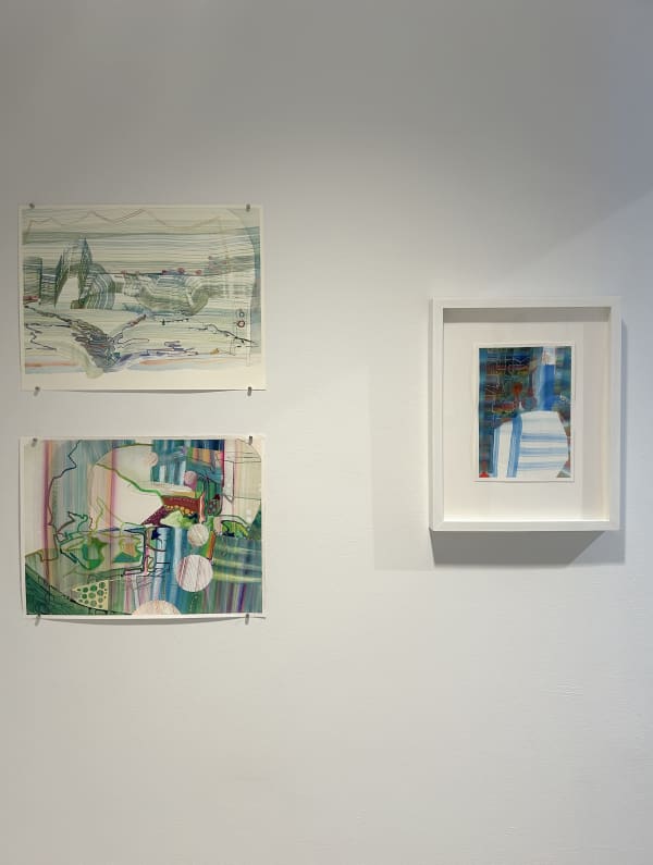 exhibition with three works on a wall. There is one framed watercolor painting, and two unframed, one on top of the other