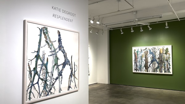 Two large watercolor paintings of colorful tree branches by Katie DeGroot on gallery walls.