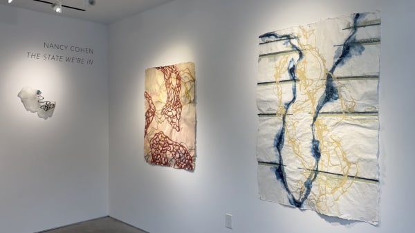 Small glass sculpture and two large colorful handmade paper drawings on gallery walls by Nancy Cohen from the exhibition "The State We're In."