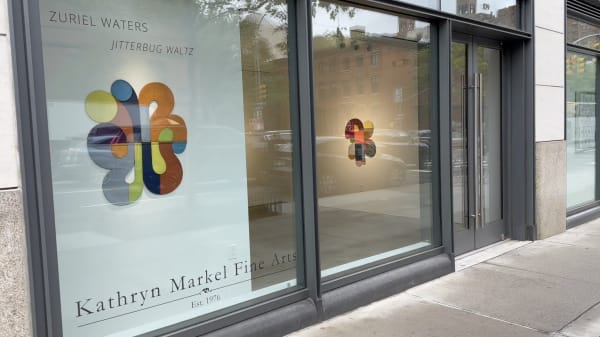 KATHRYN MARKEL Fine arts gallery window with colorful shaped and sewn paintings on the walls.