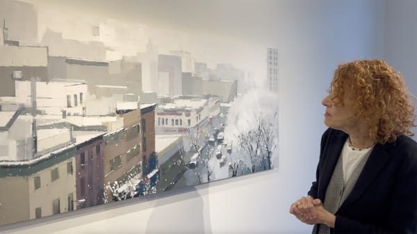 Lisa Breslow standing in front of her painting "Balcony View."