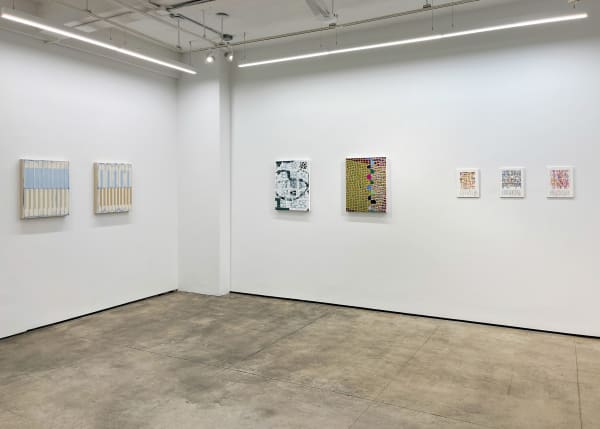 Artworks hanging in a gallery.