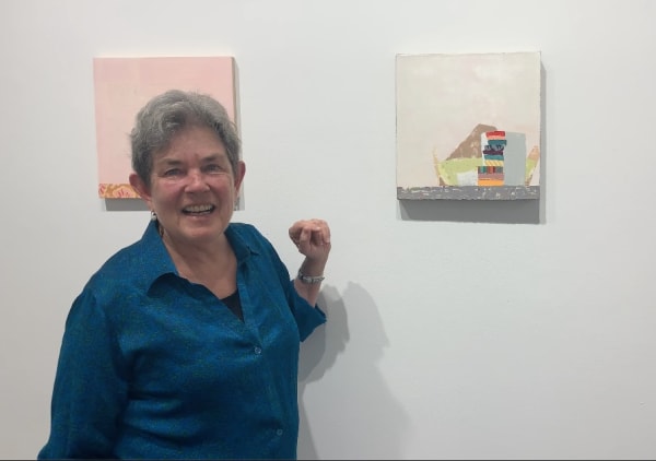 Kathryn Markel with two still life paintings by Sydney Licht.