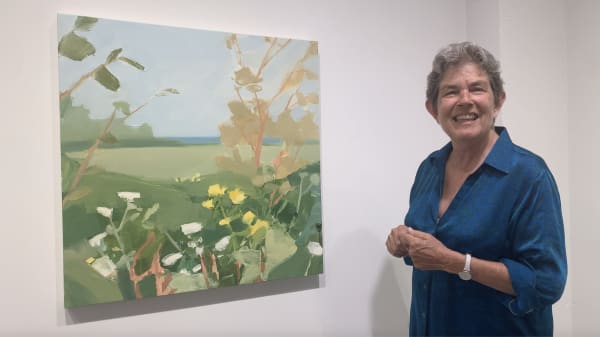 Kathryn Markel with landscape painting.