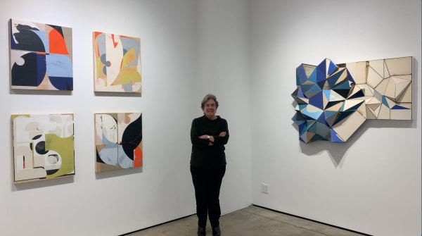 picture of Kathryn Markel standing next to contemporary art