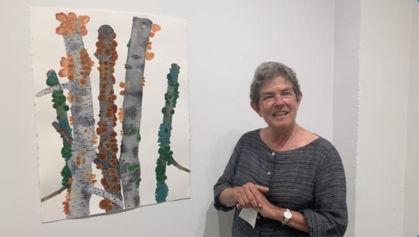 Kathryn Markel with a watercolor painting of tree branches