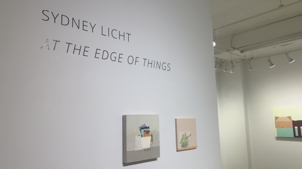 Gallery wall featuring two small still life paintings by artist Sydney Licht in a show entitled At the Edge of Things.