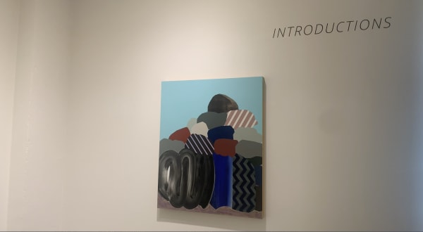 Abstract art painting on gallery wall with Introductions, title of exhibition, on wall above painting