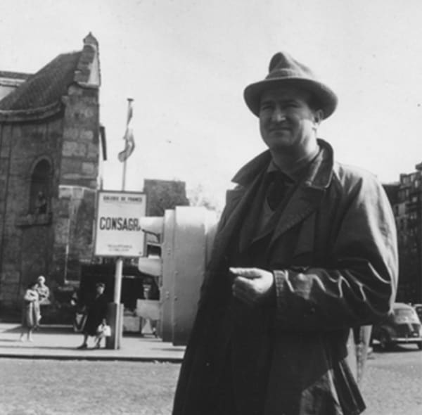 Pietro Consagra photographed in front of the advert for his solo show hosted at Galerie de France, Paris, 1959. Curtesy of Pietro Consagra online Archive.