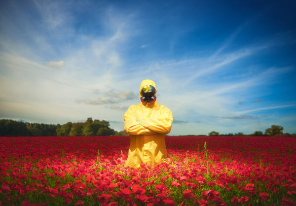 george Mcleod, Tree Huggers from the future, a man in the yellow hazmat suit, protective gear, protective mask standing in the middle of the red poppy filed, a blue sky with gentle clouds above, fine art surreal print, happy vibes, smile, mmx gallery, pri