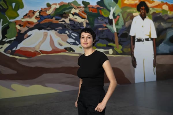 Thea Perkins beside her mural Stockwoman installed at Carriageworks.
