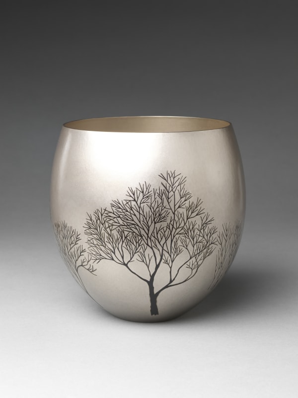 Okuyama Hōseki (Japanese, born 1937). Winter Grove (Fuyu no kodachi) Flower Container, 1997. Heisei period (1989–2019). Hammered silver with inlaid copper and gold alloy (shakudō), copper and silver alloy (shibuichi). H. 7 1/2 in. (19.1 cm); Diam. 7 1/2 in. (19.1 cm). The Metropolitan Museum of Art, Gift of Hayashi Kaoru, in celebration of the Museum’s 150th Anniversary, 2020 (2020.76.5). Image © Okuyama Hōseki