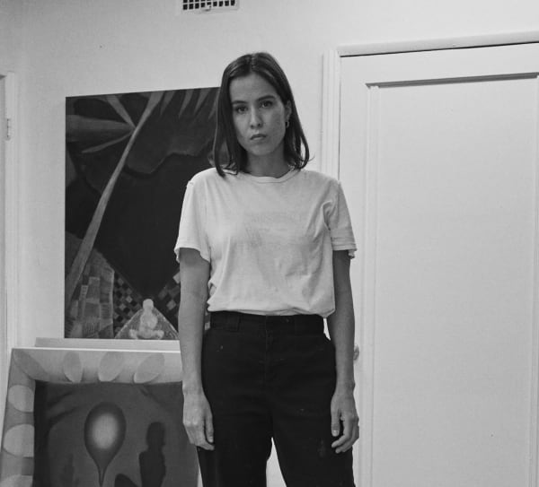 Black and white photograph of artist Kristy Luck in her studio.