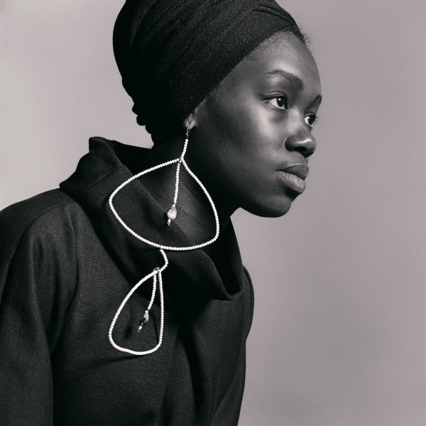Kwame Brathwaite, Untitled (Nomsa Brath with earrings designed by Carolee Prince) (1964). Archival pigment print.