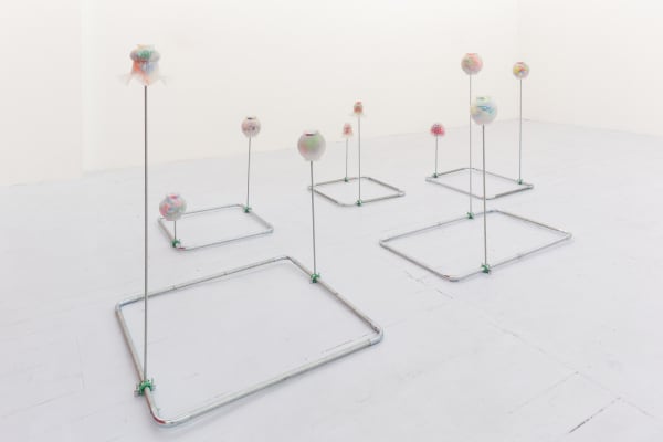 Ana Cvorovic Murky Waters 2019 steel tubes-threaded rods - glass light globes -child swimsuits -crochet dollies -bedding -fishing floats DImensions variable